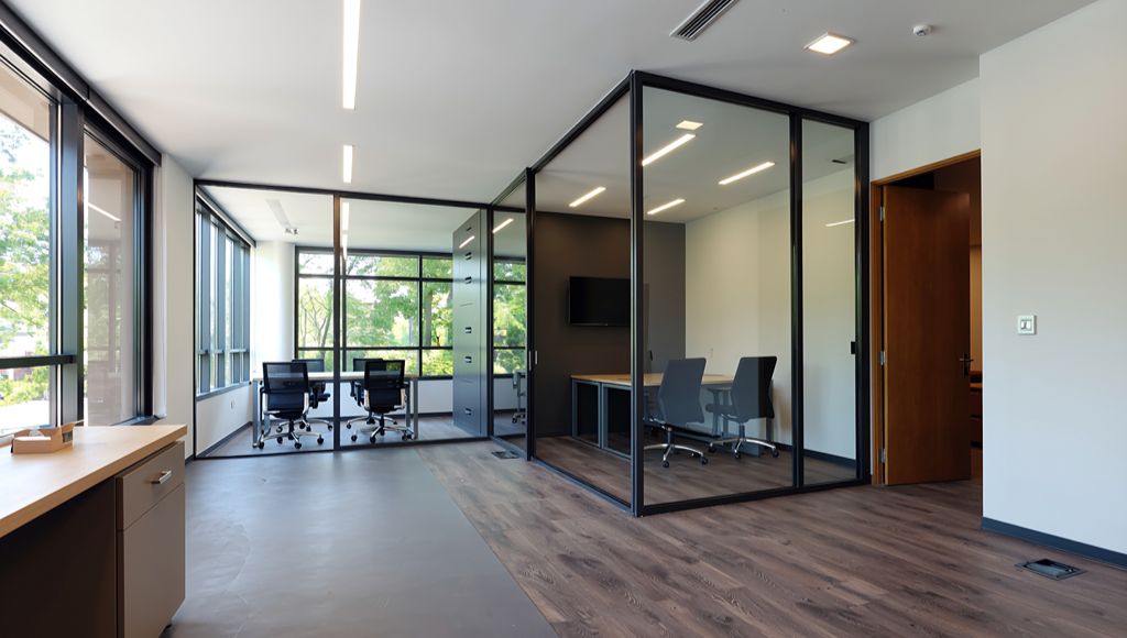 Completed commercial office interior with glazed meeting rooms and workspace areas